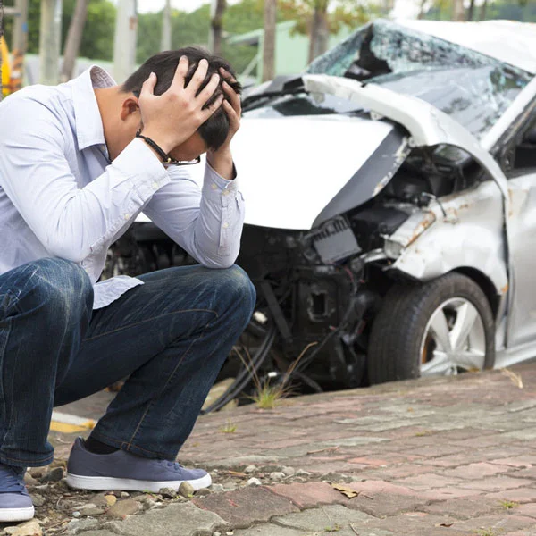 man in despair after car accident